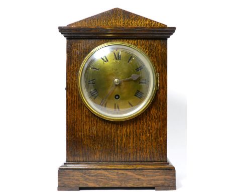 An oak RAF mantel timepiece, circa 1940, architectural pediment, 5-1/4-inch dial with Roman numerals and inscribed RAF, singl