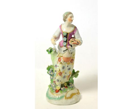 A Derby porcelain figure of a girl, circa 1770, standing holding a flask, on a scroll moulded base, 18.5cm high  Provenance: 