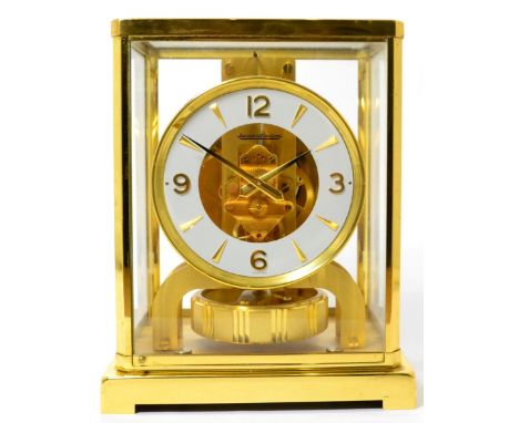 A brass atmos clock, signed Jaeger LeCoultre, case with glass panels, white chapter ring with Arabic and dagger markers, larg
