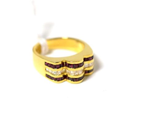 A diamond and ruby ring, a band of baguette cut diamonds in a yellow channel setting, between two bands of square cut rubies,