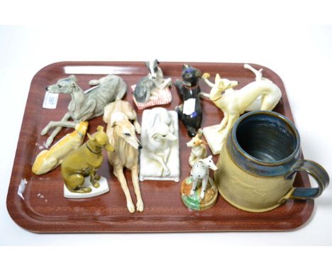 A Chinese cloisonne enamel figure of a dog, 20th century, 13cm long; ten various ceramic hounds; and a stoneware mug applied 