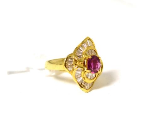 A ruby and diamond cluster ring, an oval cut ruby in a yellow claw setting, within a fancy border of channel set tapered bagu