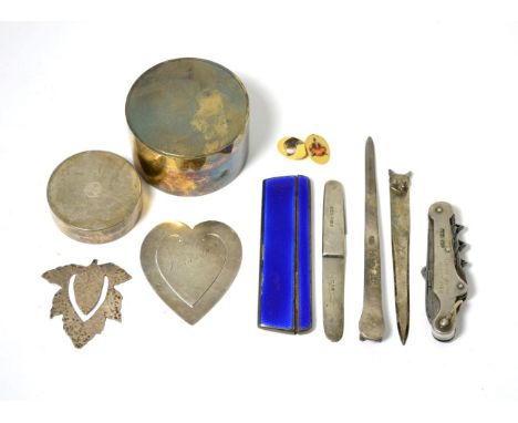A yellow metal cufflink enamelled with dogs' heads, stamped 18CT; a silver fox mask clip, Chester 1929 for Aspreys; a similar