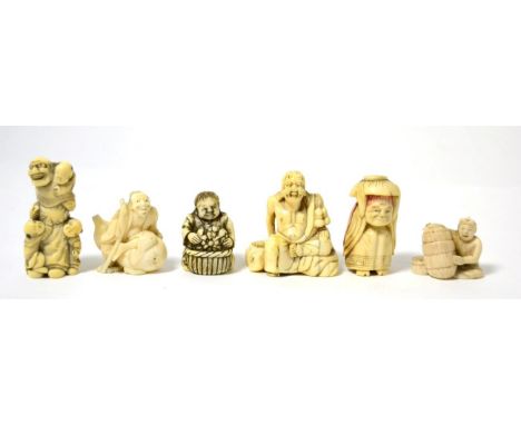 A Japanese ivory netsuke as a man with three children, 6cm high; another as a man on a large gourd, 4cm high; and four furthe