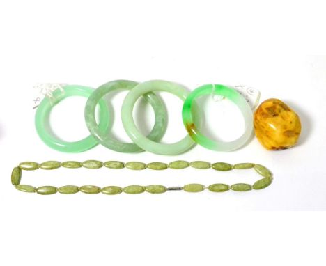 Four jade type bangles, a boulder and a necklace       