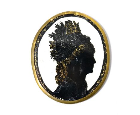 An early 19th century silhouette portrait of a lady with elaborate headdress, highlighted in gilt, 10cm by 8.5cm      