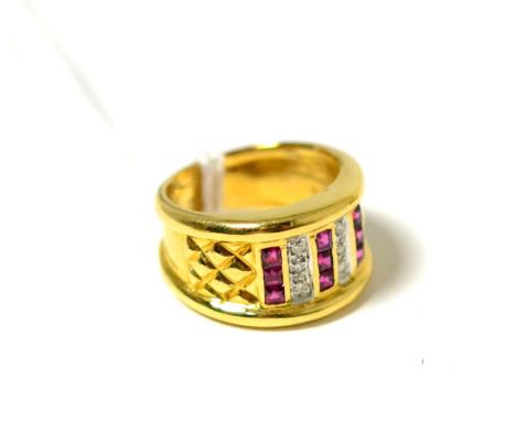 A ruby and diamond ring, three columns of step cut rubies in yellow channel settings, spaced by round brilliant cut diamonds,