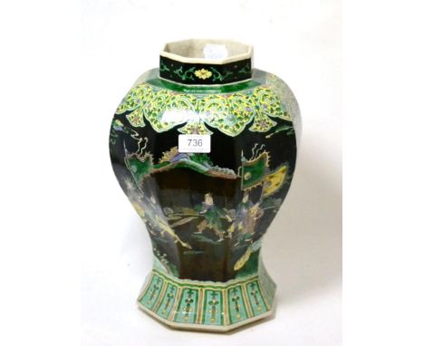 A Chinese famille noire hexagonal baluster vase painted with warriors, bearing Kangxi reign mark, 36cm high      