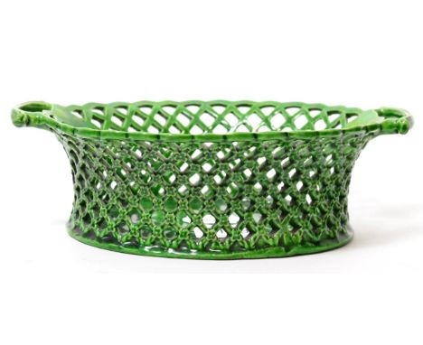 A green glazed oval basket, circa 1770, with twin scroll handles, 22cm wide      Light crazing to glaze overall. Otherwise go