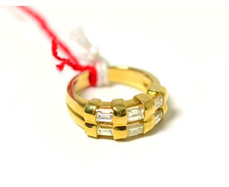 A diamond ring, two rows of baguette cut diamonds in yellow rubbed over settings, on a plain polished flat sided shank, total