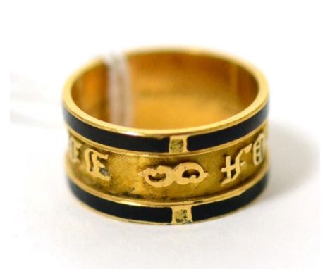 A Victorian 18ct gold black enamel mourning ring, an inner recessed band with a picked out inscription 'In Memory Of', betwee