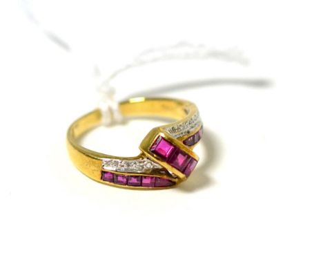 A ruby and diamond twist ring, step cut rubies in yellow channel settings with a row of pavé set eight-cut diamonds, finger s