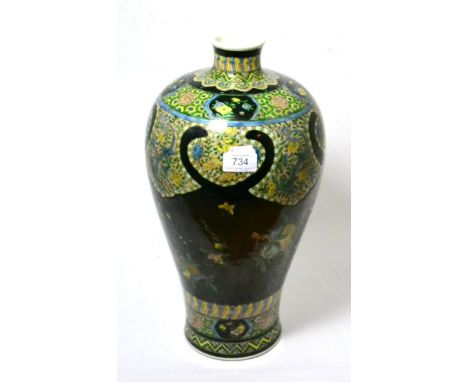 A Chinese famille noire meiping, painted with lappet shaped panels of foliage and with fruiting branches, bears six character