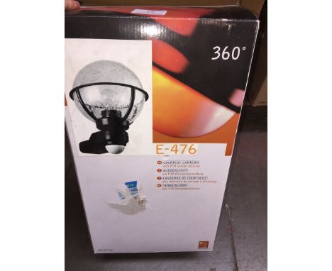 A BOXED COURTESY PAIR MOTION DETECTOR LANTERN
