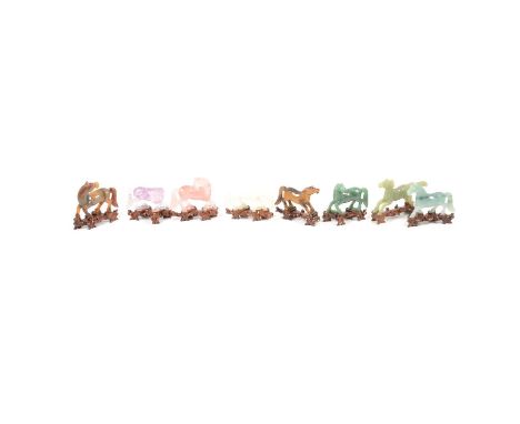 Eight modern Chinese hardstone models of horses on wooden bases to include rose quartz, amethyst, tigers eye, adventurine qua
