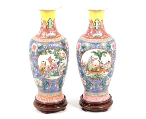 Pair of Chinese porcelain vases, the bodies painted with figural panels, enclosed by well-painted floral scrolls against a pa