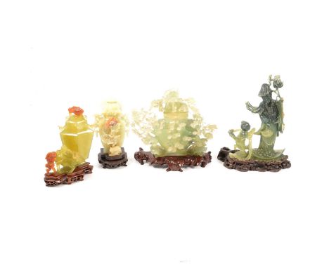 Four modern carved green jade pieces on wooden bases, Guanyin holding flowers with basket and fish, with child, 22cm; an intr