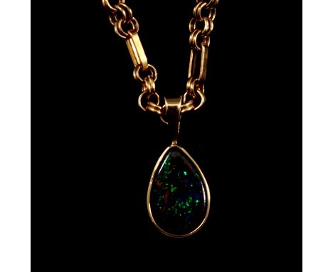 A simulated opal pendant and chain, the 13mm pear shaped opal set in a 9 carat yellow gold closed back mount on a 4mm gauge d