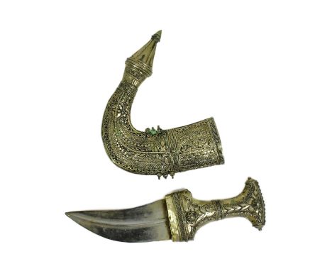 An early 20th Century Middle Eastern / Omani Khanjar / Jambiya dagger. Pressed white metal grip with a filigree band and a ma
