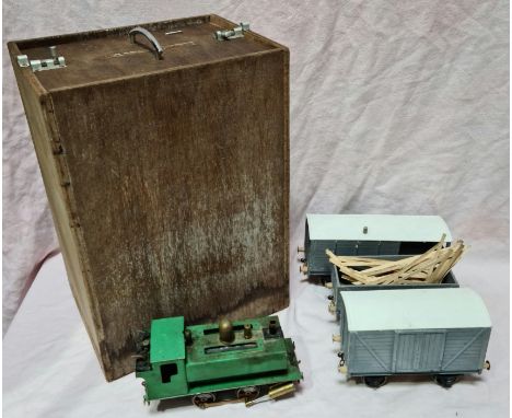 A scratch built live steam 0 gauge tank engine and three pieces of rolling stock, in wooden case.  