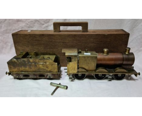 A scratch built 0 gauge live steam engine with tender and wooden case.Condition:- General wear through age and use, no sign o