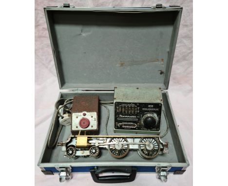 A case containing a part built engine and two controllers.  