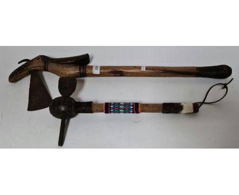 An African axe with carved bird head and another.  