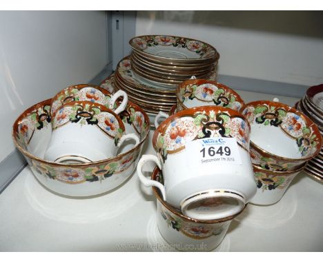 A part Teaset by Park Place china to include eight cups, saucers and plates, cake plate and slop bowl in Imari colours.