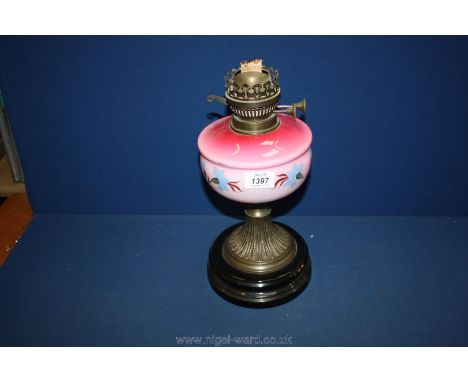 An oil Lamp with pink reservoir.