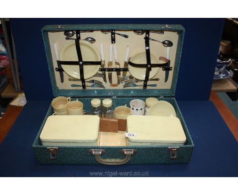 An old picnic hamper with contents, saucers, cups, sandwich boxes, and cutlery etc.