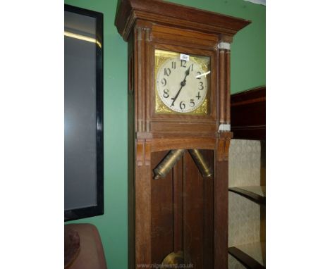 An unusual arts and crafts style Longcase Clock having carved, scratch-moulded and turned details, the brass face with brass 