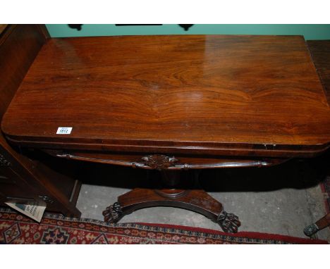 An early 19th c. Rosewood flap-over Card Table standing on a tapering turned pillar with platform base and four nicely carved