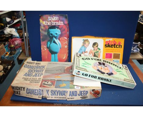 Four old games including 'Go for Broke,' 'Take the Brain,' etch-a-sketch, and camelback skyway and jeep.