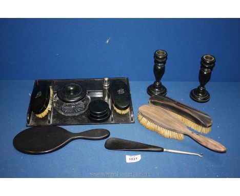 A twelve piece Ebony Dressing table set including tray, two candlesticks, mirror, button hook, shoe horn, scent bottle, cream