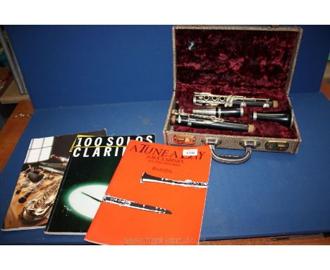 A Clarinet, cased together with music books