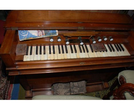 A Mahogany cased ship's Organ/harmonium having 4 1/2 octave keyboard 8 stops. 43" x 17 1/2" x 34" high; by John W Reed, 34 Ge