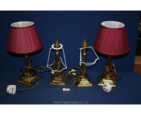 Four brass Lamp bases (short), two having maroon shades.
