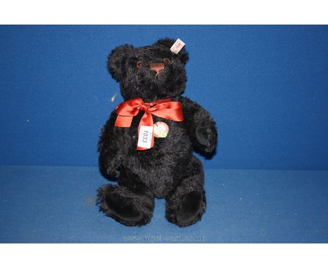 A Steiff teddy Bear, complete with tag and button.