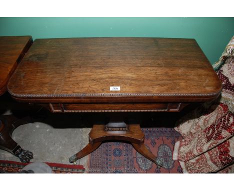 A William IV Rosewood flap-over swivel top Card Table having a green baize card playing surface and having period beaded bead