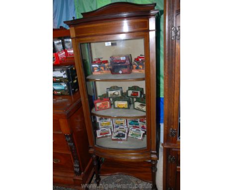 An attractive Edwardian bow fronted china Display Cabinet having light and dark wood stringing and cross banding, standing on