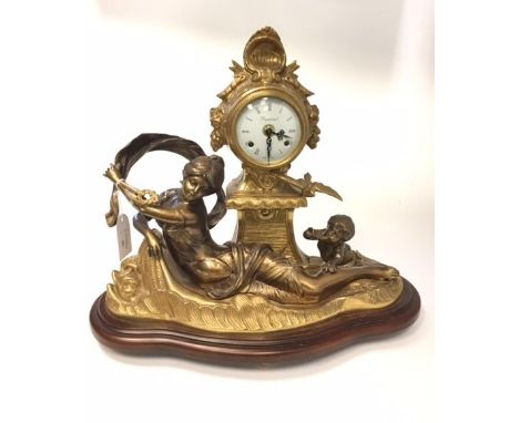 HEAVY GILT BRASS MANTEL CLOCKthe circular enamel dial with Roman numeral chapter ring and two pierced steel hands, signed 'Im