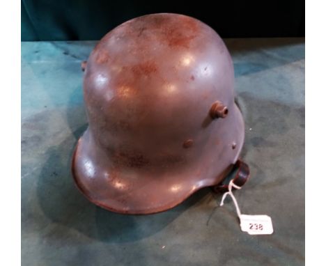 A German military helmet, probably WWI, having interior leather fitting and chin strap.