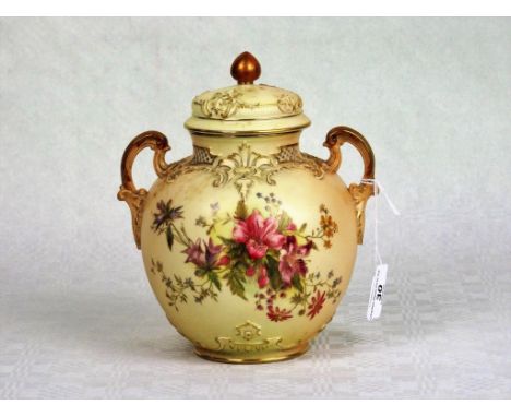 A Royal Worcester blush ivory pot pourri and cover, having twin handles with hand painted stylized floral decoration and gilt