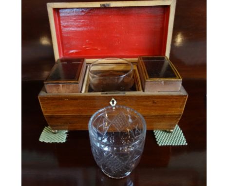 A 19th century rosewood and inlaid tea caddy of sarcophagus form on four ball supports, lion mask handles, having twin intern