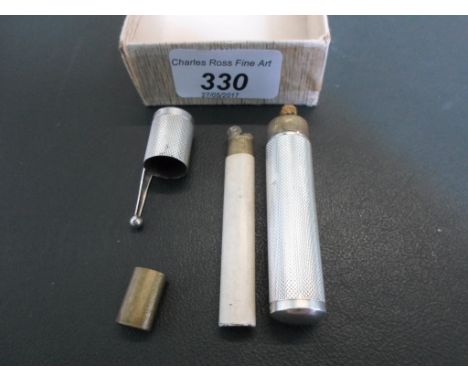 Colibri: a silver mounted lighter modelled as a pen, engine turned with pull-off cover, together with a novelty lighter model