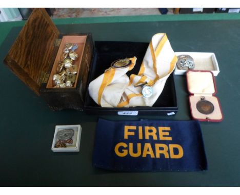 A Masonic sash and three enamel badges, together with a small quantity of military uniform badges and buttons.