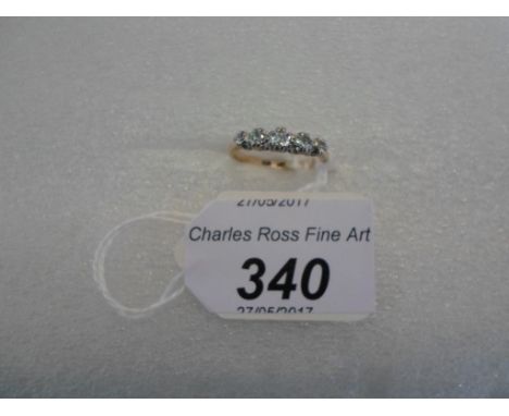 A five stone diamond half-hoop ring, the old brilliant cut diamonds in claw mounts to plain shank.