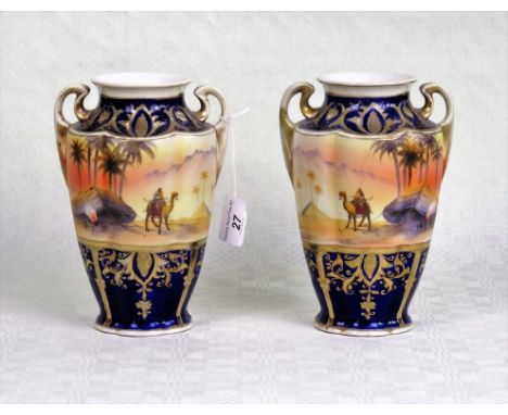 A pair of Noritake twin handled vases, each with Egyptian style decoration on a blue and gilt ground, green printed mark to b