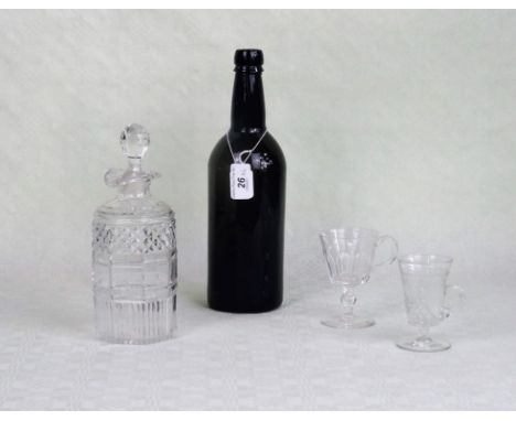 A 19th century green glass wine bottle, together with two later custard glasses and a cut glass decanter.