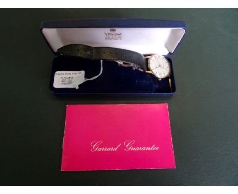Garrard: a gentleman's 9ct gold automatic wristwatch, the brushed champagne dial with baton numerals, date adjust and sweep s